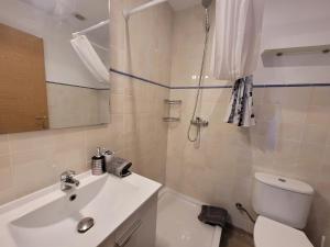 a bathroom with a white sink and a toilet at Jengina, muy centrico in Cadaqués +4 photos