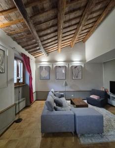 a living room with a blue couch and a table at Altobelli Apartment in Rieti
