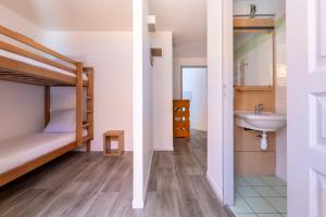 a bathroom with a bunk bed and a sink in a room at Résidence Odalys Le Pelvoux in La Plagne +68 photos