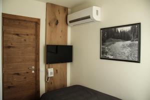 a room with a bed and a door and a fan at B&B Villa Panuka in Pančevo