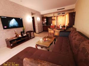 a living room with a couch and a tv at Royal Beach Premium Residence- Sunny Beach in Sunny Beach