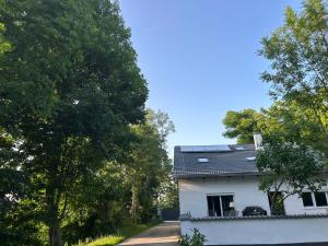a white house with solar panels on the roof at Natur pur Katharina in Kraiburg am Inn