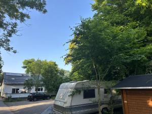 an rv parked in a driveway next to a house at Natur pur Katharina in Kraiburg am Inn
