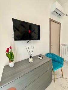 a living room with a tv on the wall at Silviaapartment in Battipaglia