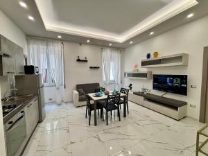 a kitchen and living room with a table and chairs at Silviaapartment in Battipaglia