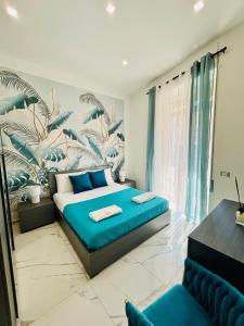 a bedroom with a large bed with a tropical mural at Silviaapartment in Battipaglia
