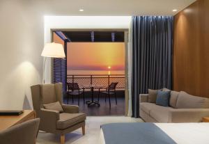 a hotel room with a view of the ocean at Nana Golden Beach All Inclusive Resort & Spa in Hersonissos