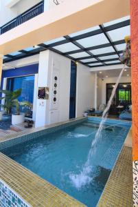 a pool with a water fountain in a house at u hend villa in Hengchun South Gate +144 photos