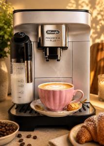 a coffee machine with a cup of coffee on a plate at Apartament Pers - komfortowy relaks przy kominku i klimatyzacji in Szczawno-Zdrój