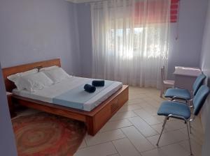 a bedroom with a bed and two chairs and a desk at Résidence Mialy in Manankasina