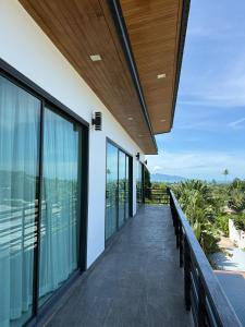 a balcony of a house with a view of the ocean at Villa Fiesta, 5bd, palace in Mae Nam +1 photo