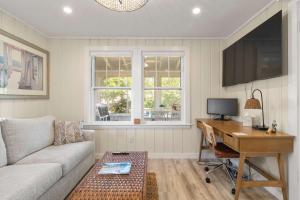 a living room with a couch and a desk at Steps to the Beach Cozy Central AC in Yarmouth