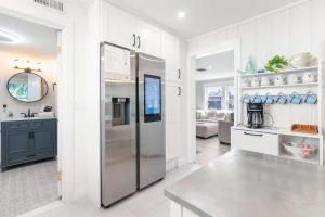 a kitchen with a stainless steel refrigerator at Steps to the Beach Cozy Central AC in Yarmouth