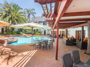 a patio with a table and chairs and a pool at Constantia Hotel and Conference Centre in Midrand