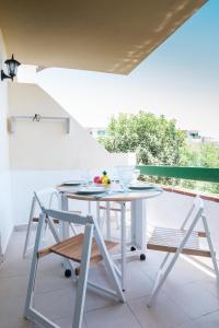 a white table and two chairs on a balcony at Rayito de sol 3 in Costa de Antigua