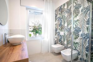 a bathroom with a tub and a sink and a toilet at Corte Fossalta - Casa Linda in Lazise +60 photos