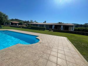 a backyard with a swimming pool and a house at Villa Beafe' Ogliastra con piscina in Tertenìa
