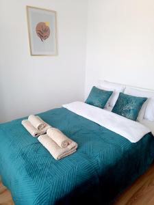 a bedroom with a large bed with towels on it at Royal Nest Apartment Sandomierz in Sandomierz