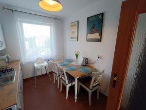 a kitchen with a table and chairs in a room at Royal Nest Apartment Sandomierz in Sandomierz