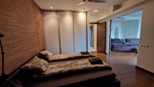 a large bed in a room with a couch at Modern skyline-view condo at a luxury complex in Vilnius