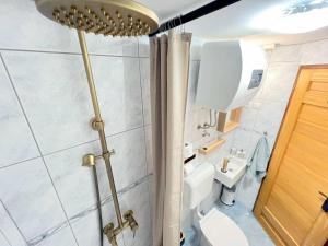 a small bathroom with a toilet and a sink at Casa Bella Holiday Home Rab in Rab