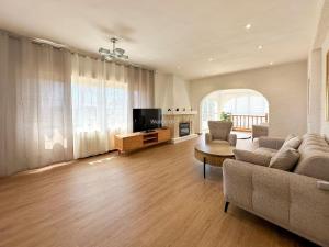 a living room with a couch and a tv at Villa Peñón View in Calpe