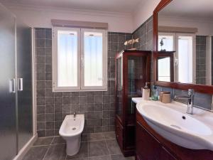 a bathroom with two sinks and a shower and a toilet at Villa Peñón View in Calpe +9 photos