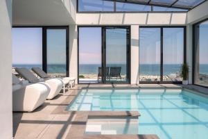 a swimming pool with a view of the ocean at Bolina Suite & Spa in Milano Marittima