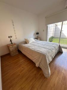 a bedroom with a large bed and a large window at Descanso Sereno in Junín