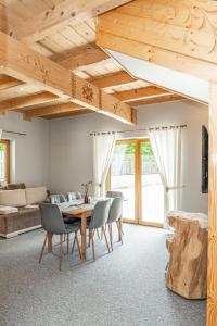 a living room with a wooden table and chairs at Kirowy Domek I in Kościelisko
