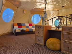 a bedroom with a bed in a tent at Bovey Heath Retreat in Bovey Tracey