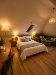 a bedroom with a large bed and a living room at Dworek w Karpaczu in Karpacz