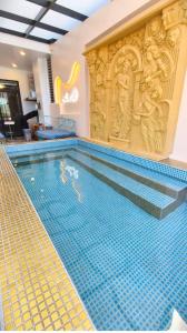 a large swimming pool in a building with a tile floor at u hend villa in Hengchun South Gate