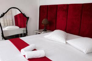 a bedroom with a bed with two towels on it at Hotel Erisun in Vlorë