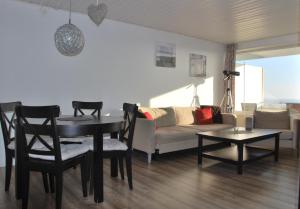 a living room with a table and a couch at Haus Nautic Whg 810 Seesicht in Cuxhaven