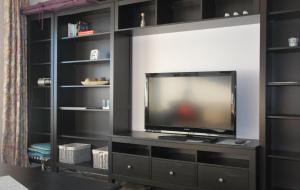 a entertainment center with a television in a living room at Haus Nautic Whg 810 Seesicht in Cuxhaven