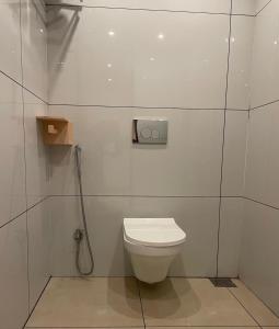 a white bathroom with a toilet and a shower at Wanderlust Beach Villa in Agatti +19 photos