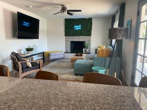 a living room with a couch and a table at Nova Gypsy Vanner by PaseoHomesAZ with Pool & Pool in Phoenix