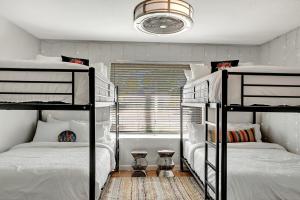 a bedroom with two bunk beds and a window at Nova Gypsy Vanner by PaseoHomesAZ with Pool & Pool in Phoenix +53 photos