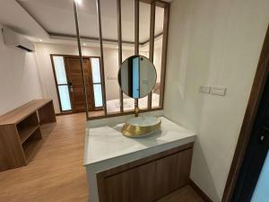 a bathroom with a sink and a mirror on a counter at Openview Resort Thakhek in Thakhek +14 photos