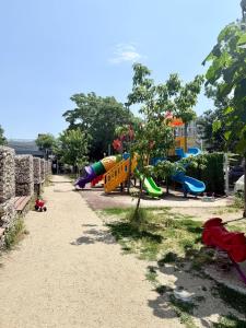 a park with a playground with slides at Contemporary Studio with Balcony - New Building in Bucharest