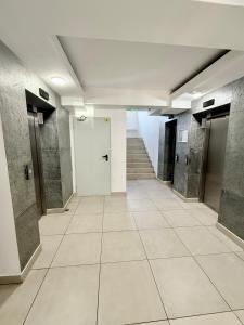 an empty hallway with stairs and elevators in a building at Contemporary Studio with Balcony - New Building in Bucharest +28 photos