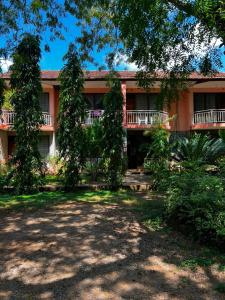 a building with trees in front of it at PRIMESHADE GUESTHOUSE in Malindi