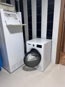 a washing machine and a washer in a bathroom at Оксамитове ретро in Ternopil +11 photos