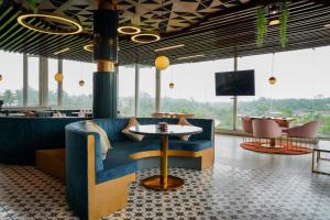 a restaurant with a blue couch and a table at SOLARAA iNN in Anjuna