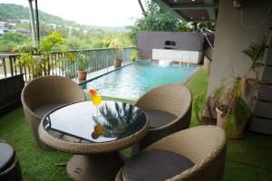 a patio with a table and chairs and a swimming pool at SOLARAA iNN in Anjuna