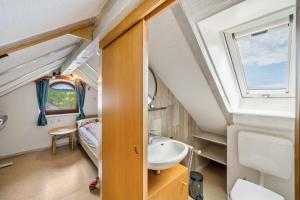 a tiny house with a bathroom and a sink at Ferienwohnung Panorama in Freiamt +24 photos