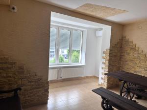 a room with a window and a wooden bench at Оксамитове ретро in Ternopil