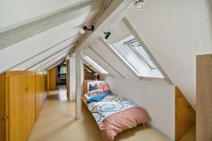 a small room with a bed in the attic at Ferienwohnung Panorama in Freiamt