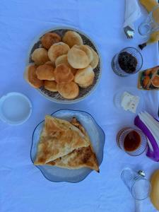a table with a bowl of crackers and a plate of food at Perseku GuestHouse in Shirokë +27 photos